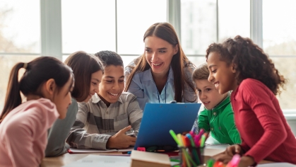 Stock photo of kids in school with teacher